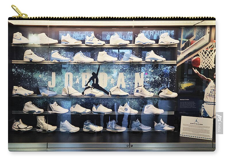 Michael Jordan Zip Pouch featuring the mixed media Historic Michael Jordan Shoe Collection by Brian Reaves