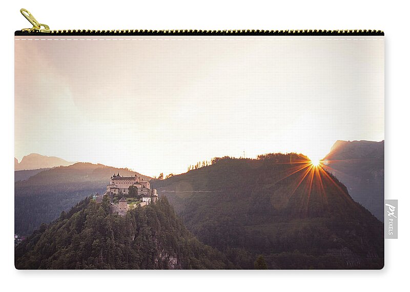 Reconstruction Carry-all Pouch featuring the photograph Hohenwerfen Castle at sunset by Vaclav Sonnek