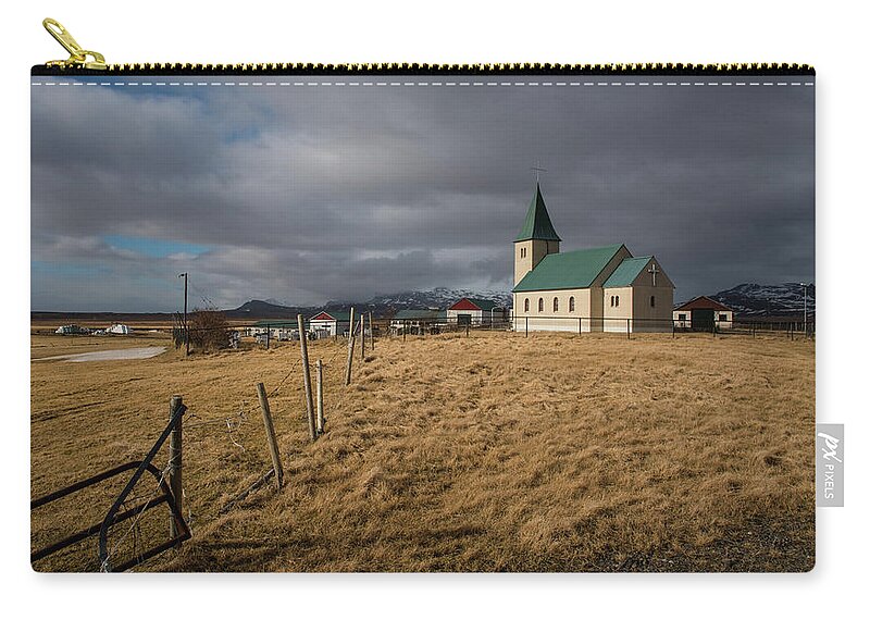 Icelandic Carry-all Pouch featuring the photograph Icelandinc landscape with traditional church in Iceland by Michalakis Ppalis