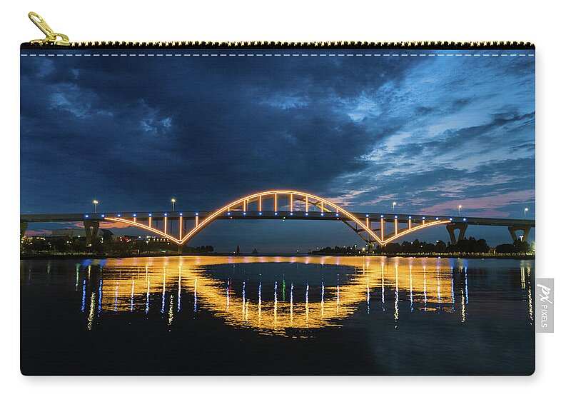 Port Of Milwaukee Zip Pouch featuring the photograph Light the Hoan in Blue and Gold by Kristine Hinrichs