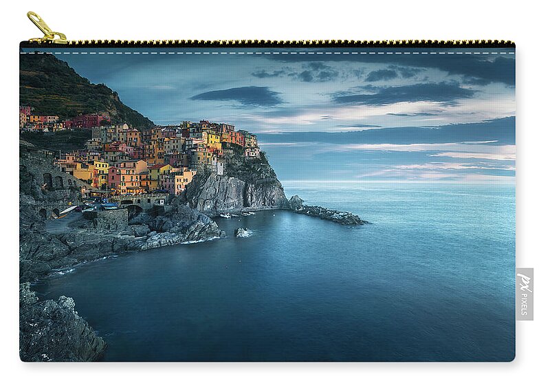 Manarola Zip Pouch featuring the photograph Manarola village, rocks and sea in blue hour. Cinque Terre, Ital by Stefano Orazzini