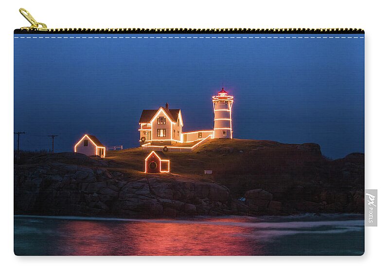 Maine Lighthouse Zip Pouch featuring the photograph Nubble lighthouse with Christmas Lights by Jeff Folger