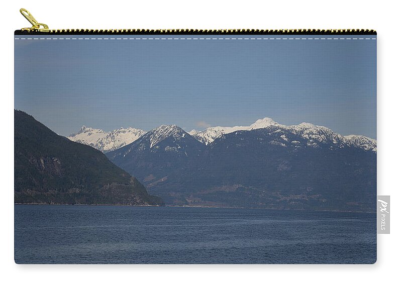 Ocean Zip Pouch featuring the photograph Ocean leading to Snow Capped Mountains by James Cousineau