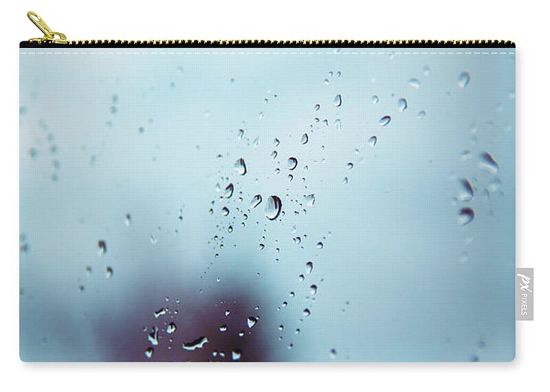 Window Zip Pouch featuring the photograph Rain drops on a window surface with blurry shadows by Mendelex Photography