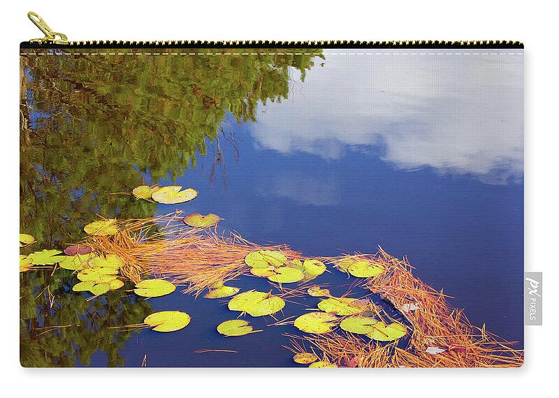 Blue Zip Pouch featuring the photograph Reflections in a lily pond by Charles Floyd