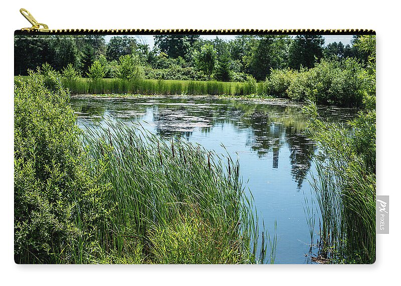 Reflections In A Pond Zip Pouch featuring the photograph Reflections in A Pond by Tom Cochran