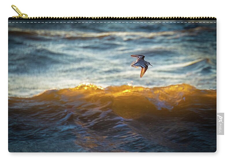 Hammonasset Zip Pouch featuring the photograph Sanderling Over Sunset Wave Glow by Mark Roger Bailey
