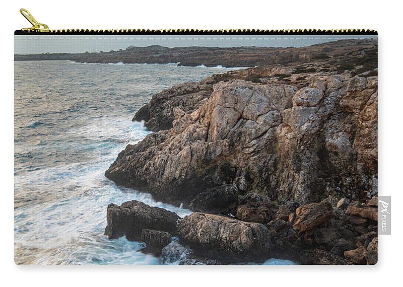 Stormy Sea Carry-all Pouch featuring the photograph Seascape with windy waves during stormy weather at sunset. by Michalakis Ppalis