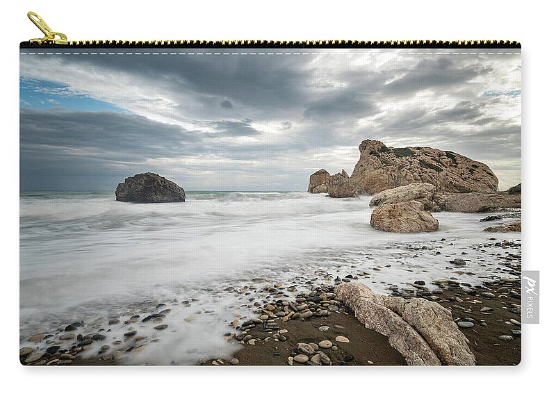 Seascape Carry-all Pouch featuring the photograph Seascape with windy waves splashing at the rocky coastal area. by Michalakis Ppalis