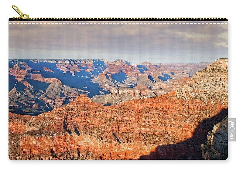 Arid Climate Zip Pouch featuring the photograph Shadows Creep Over the Canyon at Dusk by Jeff Goulden