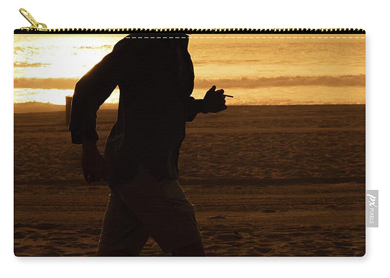 Silhouette Zip Pouch featuring the photograph Silhouette of a tall man running on beach at sunset stock photo by Mark Stout