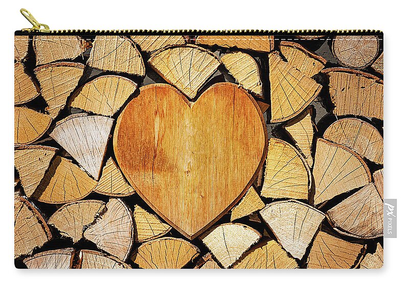 Pile Zip Pouch featuring the photograph Stack of firewood with a wooden heart by Bernhard Schaffer