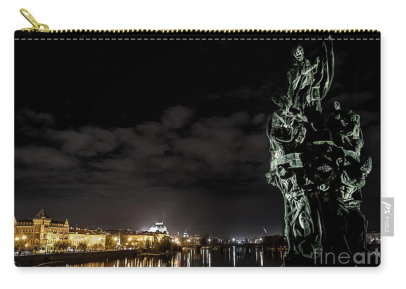 Ancient Zip Pouch featuring the photograph Statue On Charles Bridge And Illuminated Buildings In Prague In The Czech Republic by Andreas Berthold