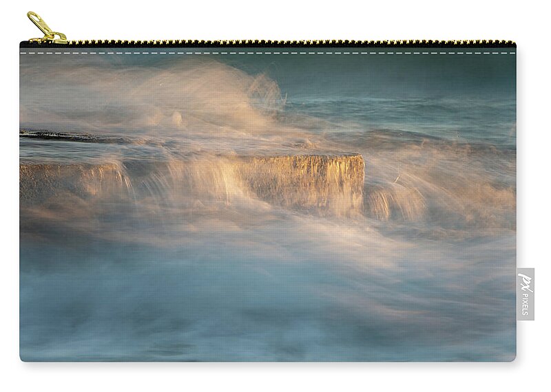 Stormy Sea Zip Pouch featuring the photograph Stormy windy sea waves splashing on a rocky seashore at sunset by Michalakis Ppalis