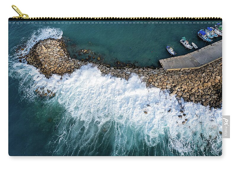 Brakewater Carry-all Pouch featuring the photograph Stormy windy waves on the shore. Drone photography. by Michalakis Ppalis