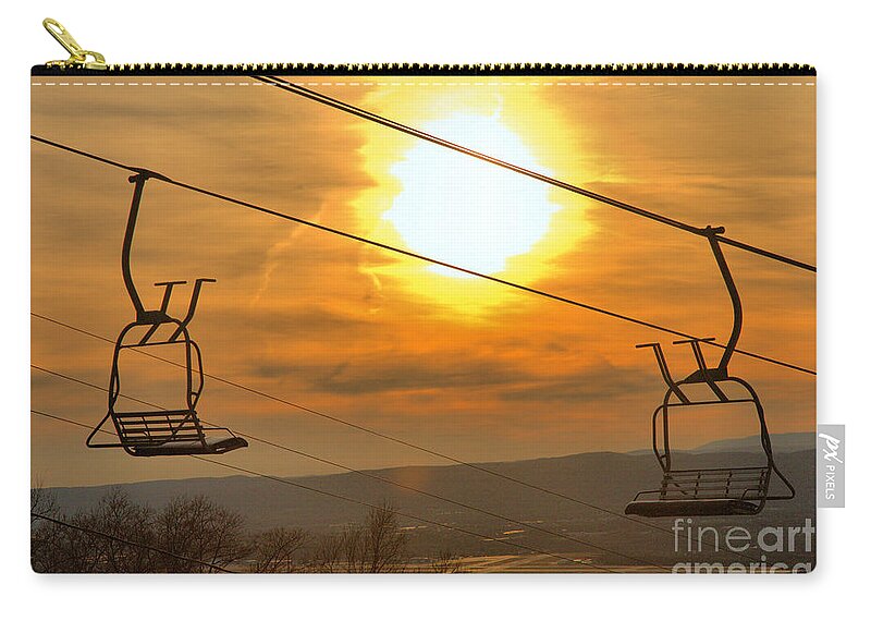 Montage Zip Pouch featuring the photograph Sunburst Over The Montage Chairlift by Adam Jewell