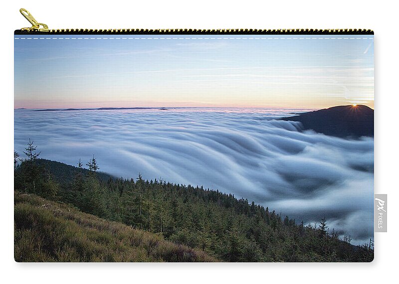 Courage Carry-all Pouch featuring the photograph Sunset with floating blue waves of clouds by Vaclav Sonnek