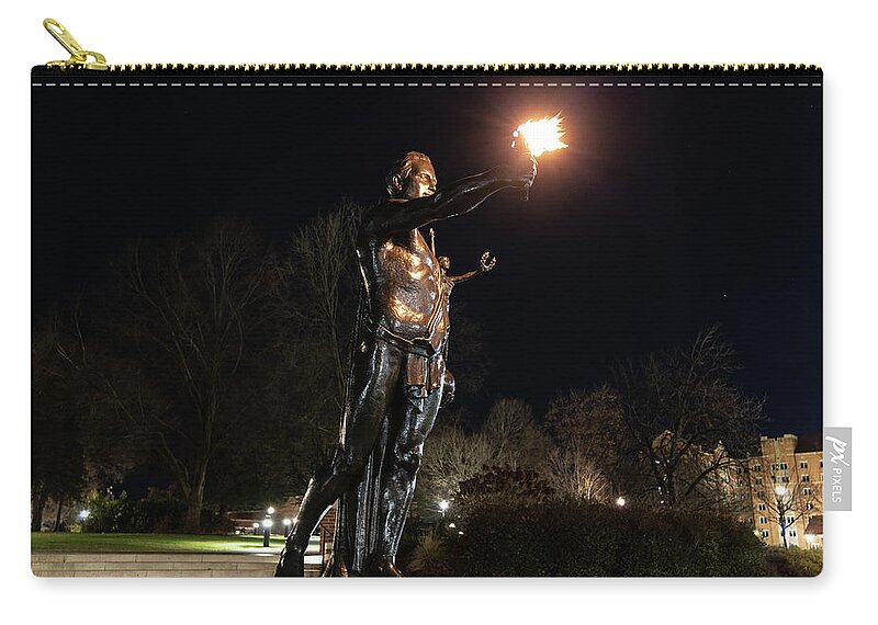 University Of Tennessee At Night Carry-all Pouch featuring the photograph Torchbearer statue at the University of Tennessee at night by Eldon McGraw