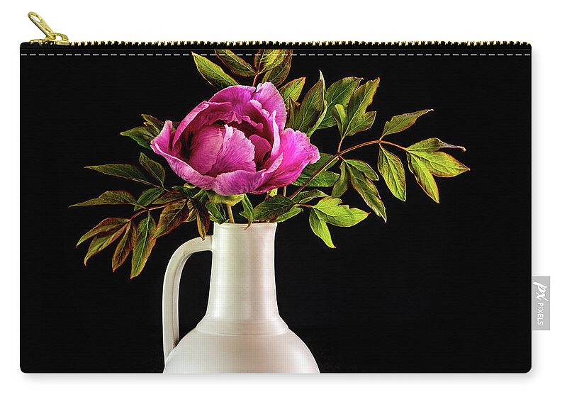 Tree Peony Carry-all Pouch featuring the photograph Tree peony Lan He Paeonia suffruticosa rockii in a white vase on a black background by Torbjorn Swenelius