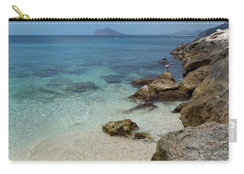 Mediterranean Zip Pouch featuring the photograph Turquoise blue sea water and rocks in Calpe 1 by Adriana Mueller