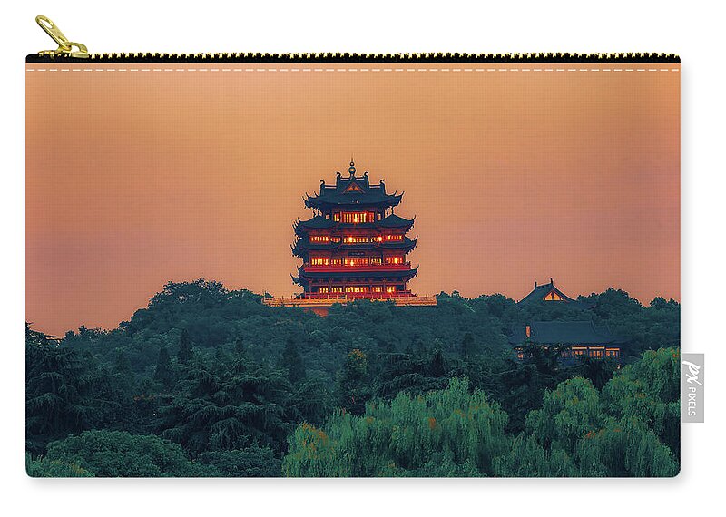 Ancient Edifice Zip Pouch featuring the photograph Twilight Glow on Liuhe Pagoda by Benoit Bruchez