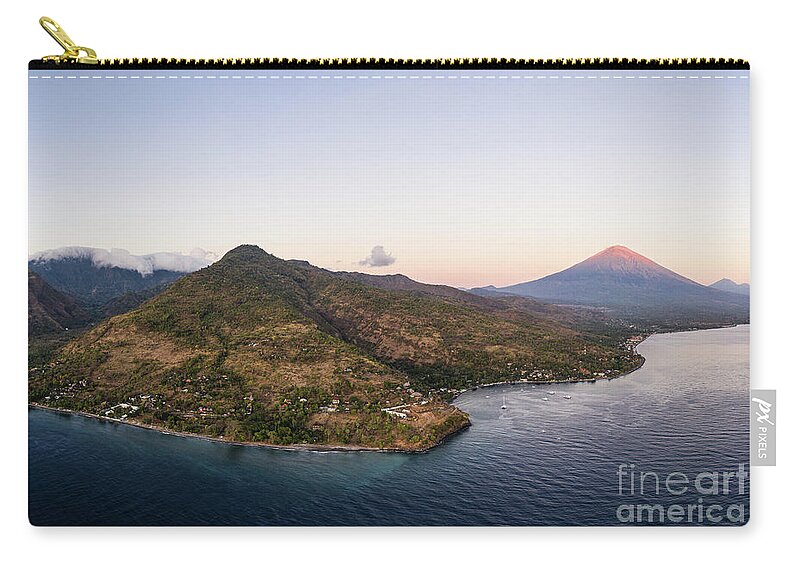 Amed Zip Pouch featuring the photograph Twilight over the north Bali coast with the Agung volcano near A by Didier Marti