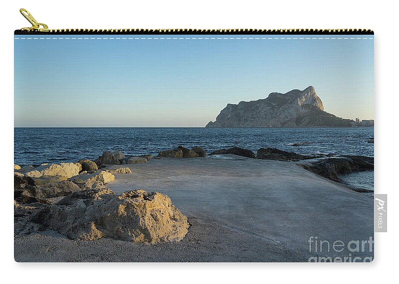 Mediterranean Coast Zip Pouch featuring the photograph Warm evening light meets deep blue by Adriana Mueller