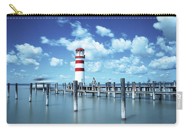Destinations Carry-all Pouch featuring the photograph White-red lighthouse in Podersdorf am See by Vaclav Sonnek