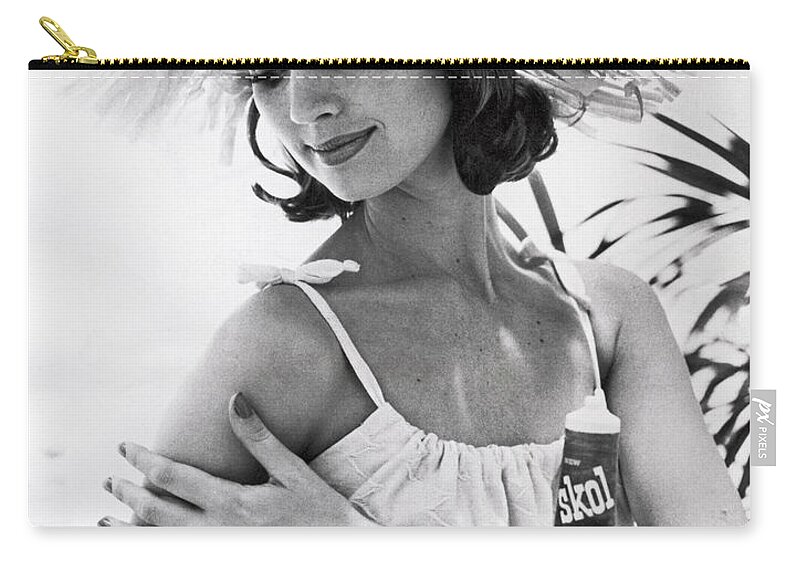  Zip Pouch featuring the photograph Young Woman Applies Tanning Cream by Underwood Archives