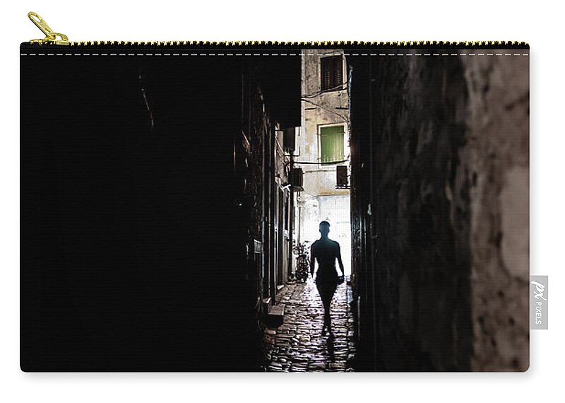  Carry-all Pouch featuring the photograph Young Woman Walks Alone Through Spooky Narrow Abandoned Alley In The Night by Andreas Berthold