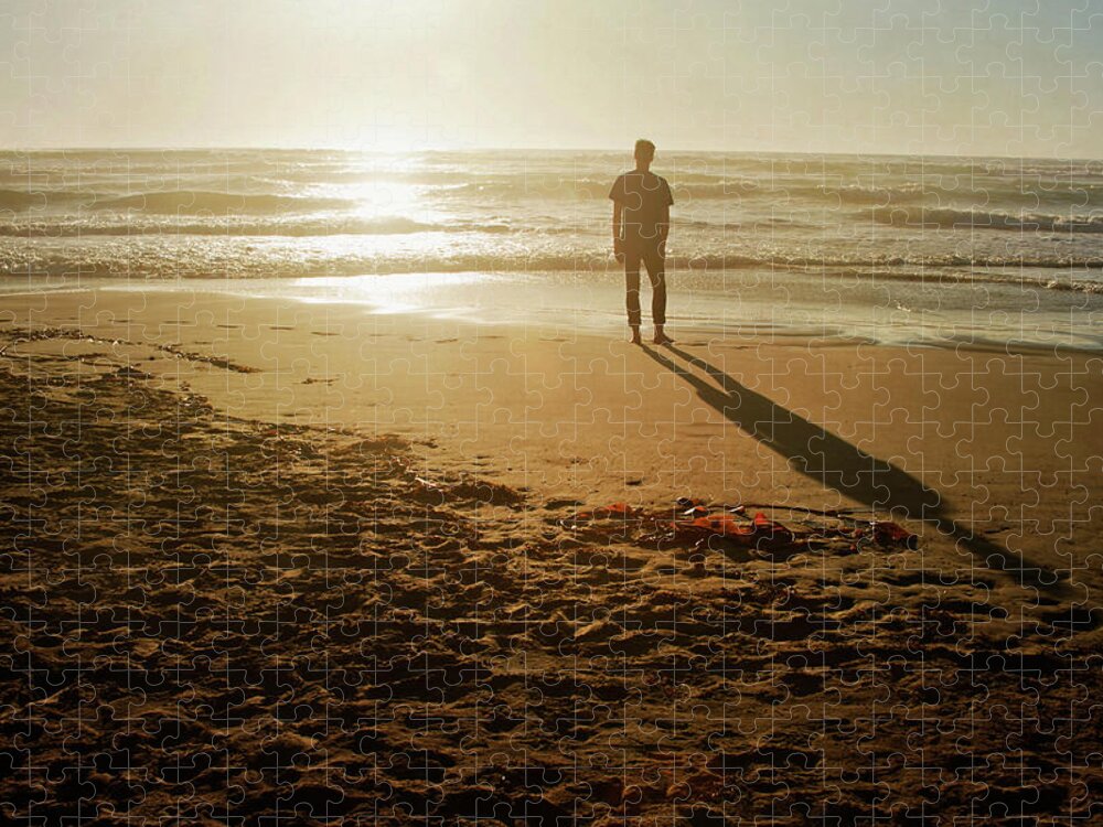 Tranquility Jigsaw Puzzle featuring the photograph A Silhouetted Figure Standing On A Beach by Tracy Packer Photography