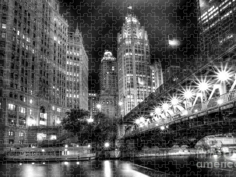 Modern; City; Cityscape; Road; Bridge; Outdoor; Outside; Perspective; Street; Transportation; Building; Chicago; Illinois; Downtown; Urban; United States; Lights; Road; Street; Michigan Avenue; Dusable Bridge; Sidewalk; Walkway; Lights; Boat; Night; Nighttime; Dark; Usa; Tribune Tower; River; Chicago River; Black And White; Monochrome Jigsaw Puzzle featuring the photograph Boat Along the Chicago River by Margie Hurwich