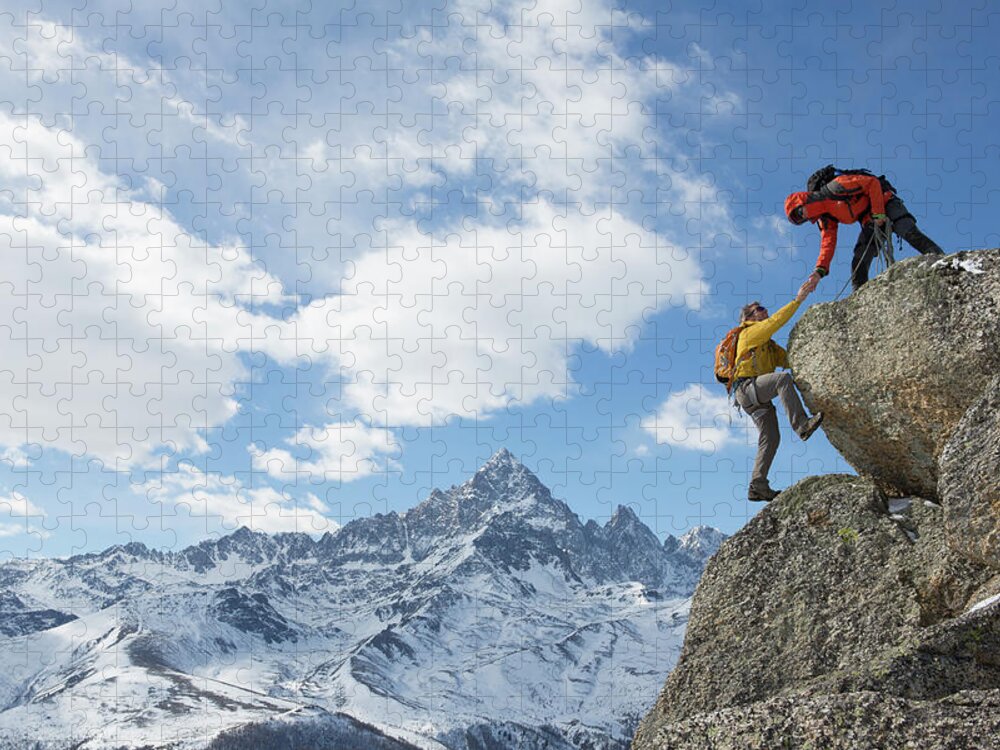 Young Men Jigsaw Puzzle featuring the photograph Climber Extends Helping Hand To Teammate by Ascent Xmedia