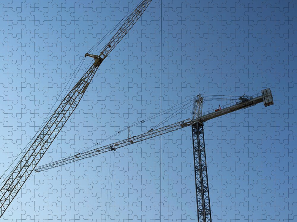 Clear Sky Jigsaw Puzzle featuring the photograph Construction Cranes Against A Blue Sky by Alvis Upitis