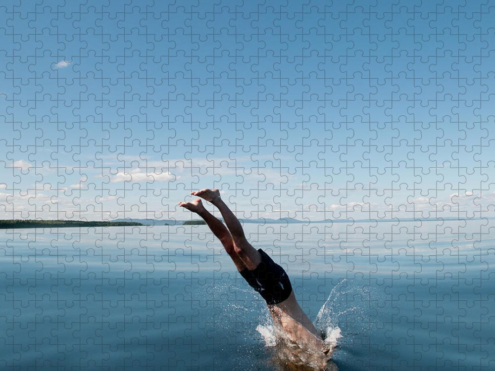 Scenics Jigsaw Puzzle featuring the photograph Mature Man Jumping In Sea by Johner Images