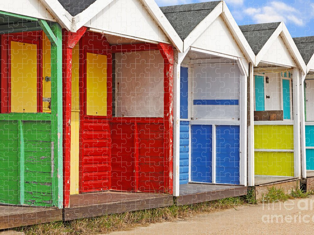 Beach Huts Jigsaw Puzzle featuring the photograph Row of old wooden beach huts by Richard Thomas