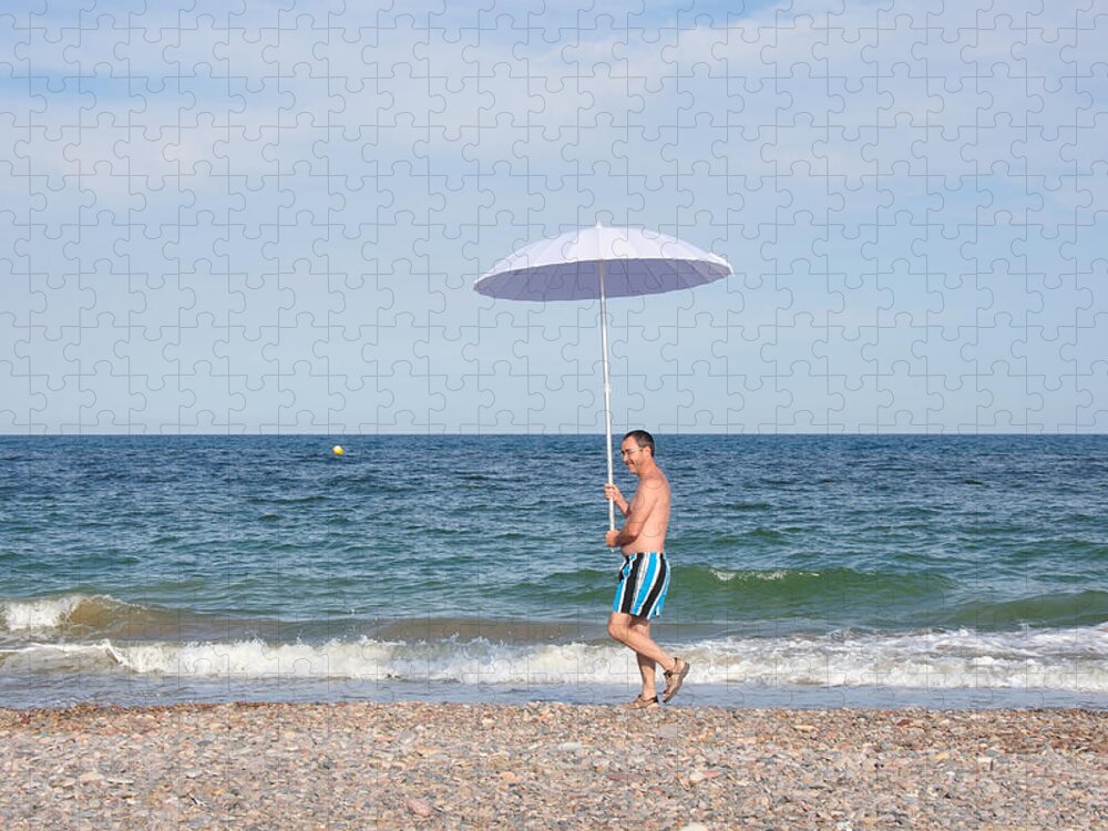 Mature Adult Jigsaw Puzzle featuring the photograph Walking On The Beach by Miguel Sotomayor