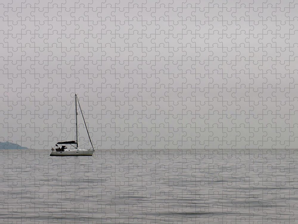 Sailboat Jigsaw Puzzle featuring the photograph Lonely sailboat in the ocean by Michalakis Ppalis