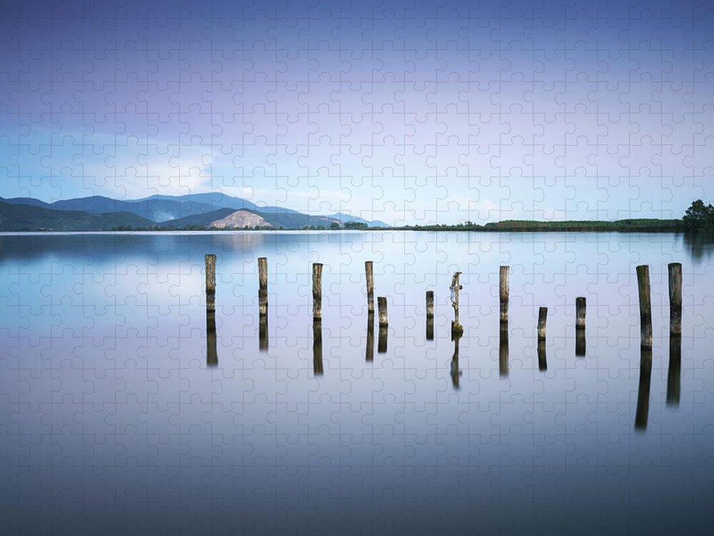 Lake Jigsaw Puzzle featuring the photograph Wooden pier or jetty remains on a blue lake sunset and sky refle #3 by Stefano Orazzini