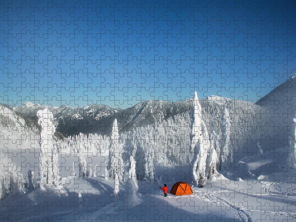 Tranquility Jigsaw Puzzle featuring the photograph A Man Walking Through Deep Powder To by Mint Images - Michael Hanson