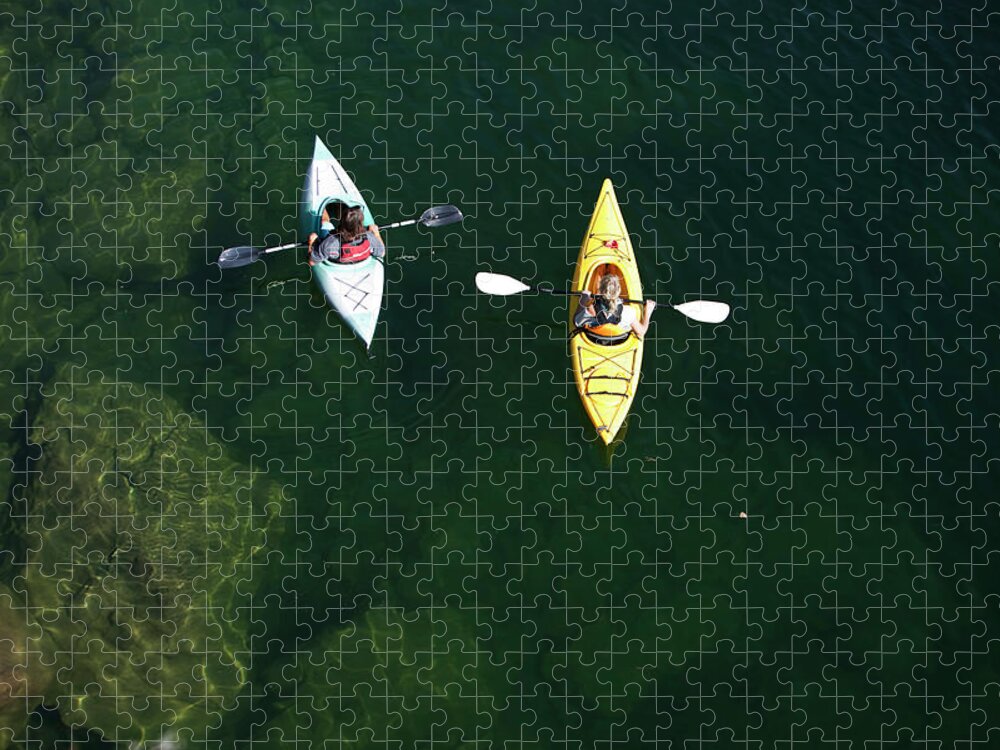 Young Men Jigsaw Puzzle featuring the photograph A Young Adult Couple Kayaking On A by Patrick Orton