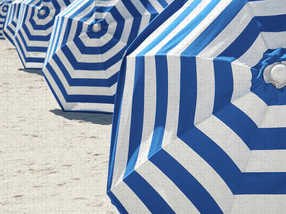 In A Row Jigsaw Puzzle featuring the photograph Bright Blue And White Striped Beach by Peskymonkey