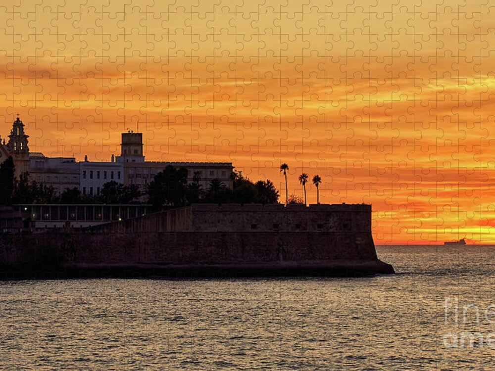 Andalusia Jigsaw Puzzle featuring the photograph Candelaria Fortress Silhouette at Sunset against Orange Sky by Pablo Avanzini