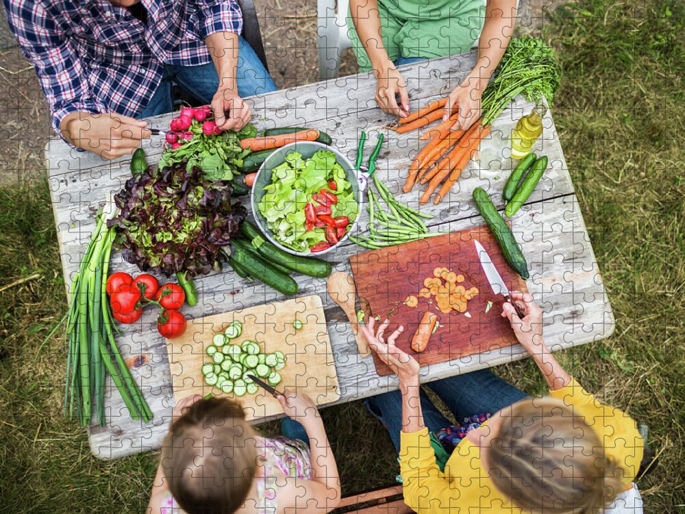 Orange Color Jigsaw Puzzle featuring the photograph Family Preparing Salad In Garden by Hinterhaus Productions