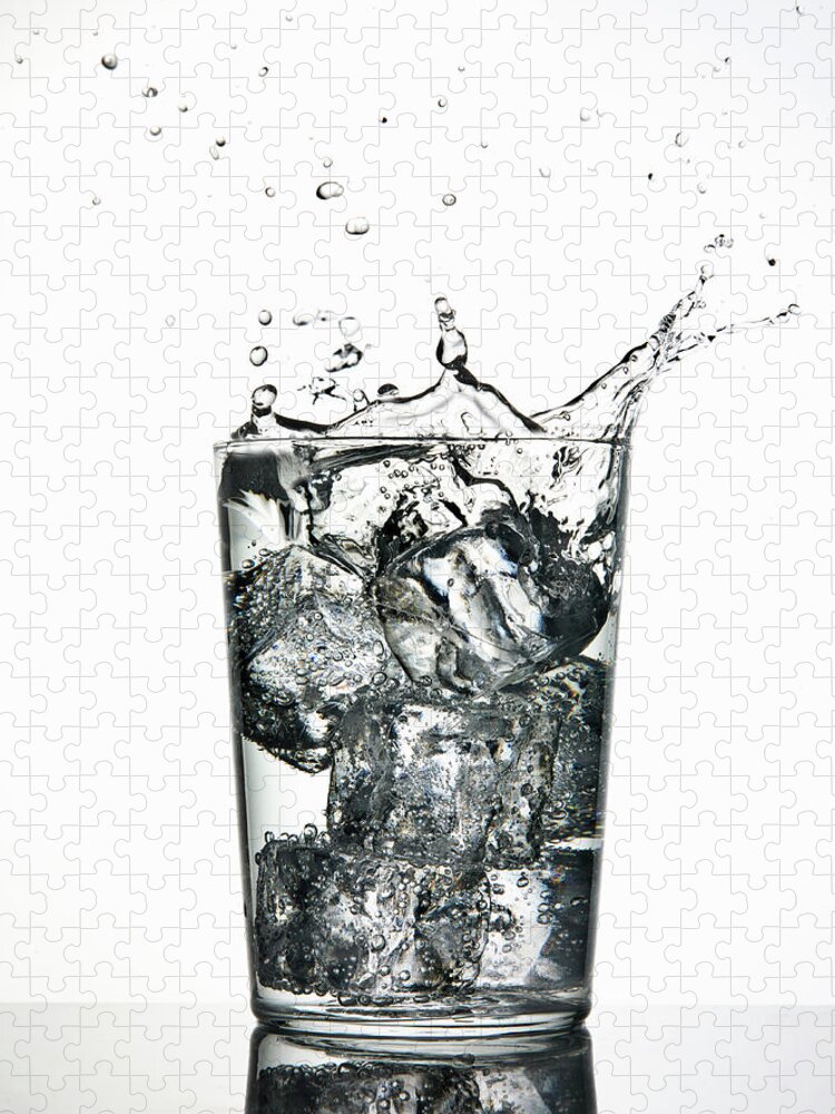White Background Jigsaw Puzzle featuring the photograph Ice Cubes Splashing Into Fizzy Drink by Walter Zerla