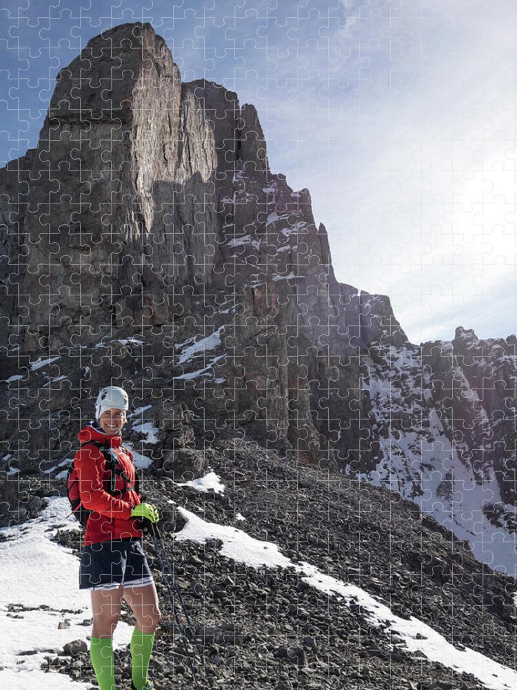 Ski Pole Jigsaw Puzzle featuring the photograph Mountain Runner Pauses On Snowy by Ascent Xmedia
