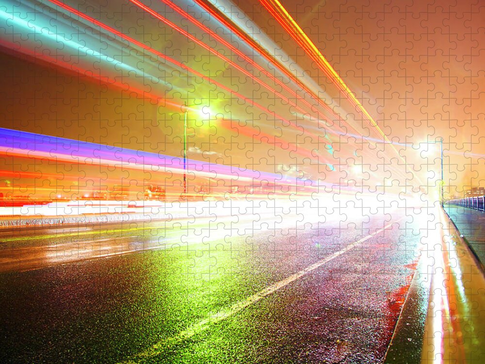 Outdoors Jigsaw Puzzle featuring the photograph Rainy Road With Blurred Traffic At Night by Thomas Northcut