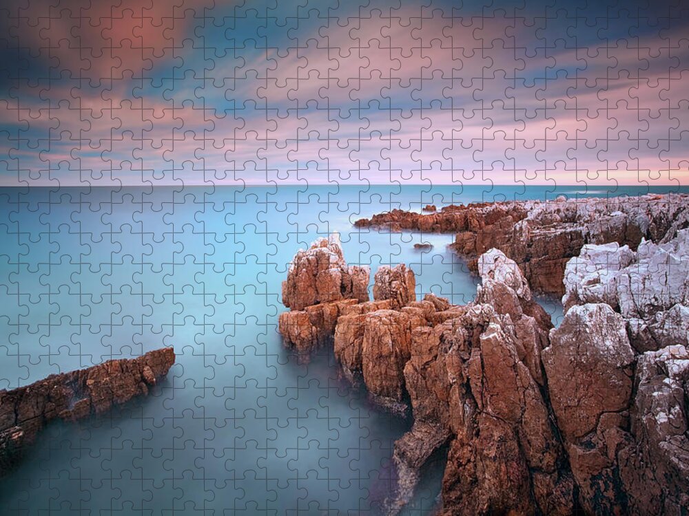Scenics Jigsaw Puzzle featuring the photograph Rocks In Sea At Sunset by Eric Rousset