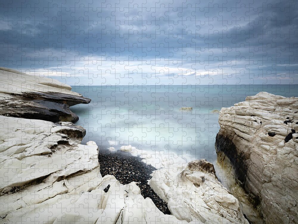 Seascape Jigsaw Puzzle featuring the photograph Rocky coast with white limestones and cloudy sky by Michalakis Ppalis