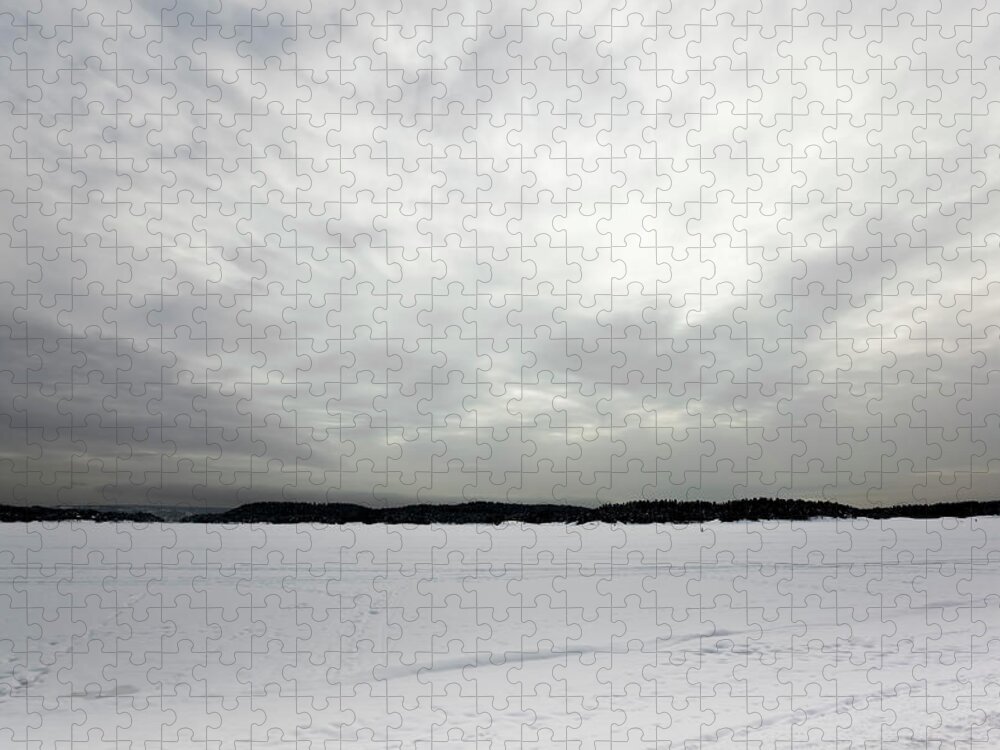 Melting Jigsaw Puzzle featuring the photograph Silver Gray Sky Over A Frozen Lake by Ekely